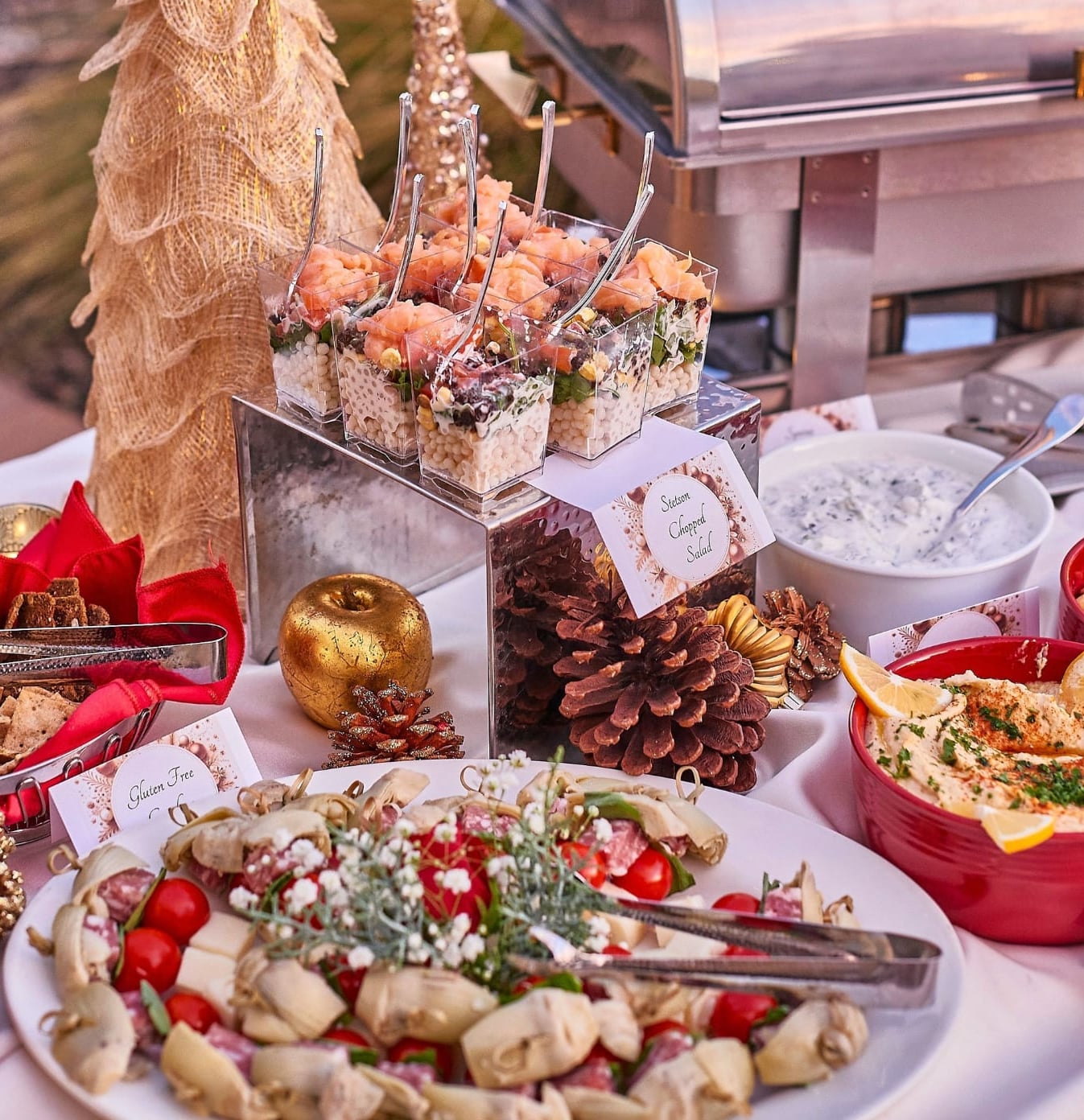 A holiday appetizer spread with smoked-salmon cups, charcuterie, and seasonal decor